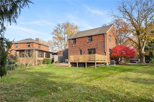 back of property featuring a yard and central air condition unit