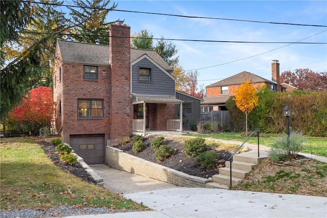 view of front property featuring covered porch and a garage