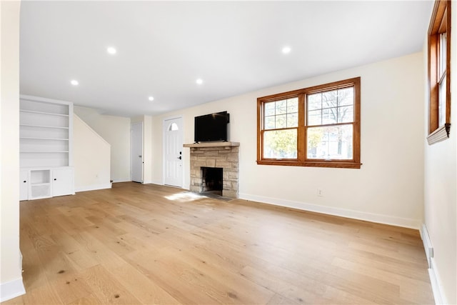 unfurnished living room featuring light hardwood / wood-style flooring and a fireplace