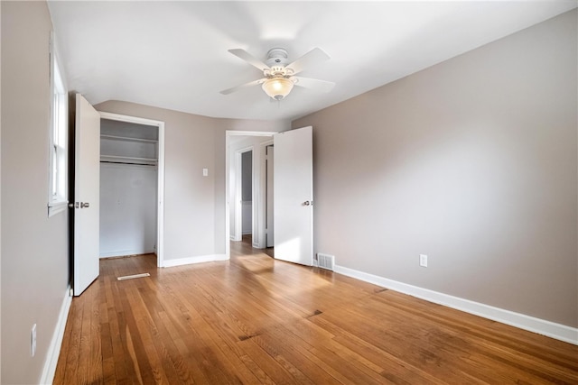 unfurnished bedroom featuring a closet, light hardwood / wood-style floors, and ceiling fan