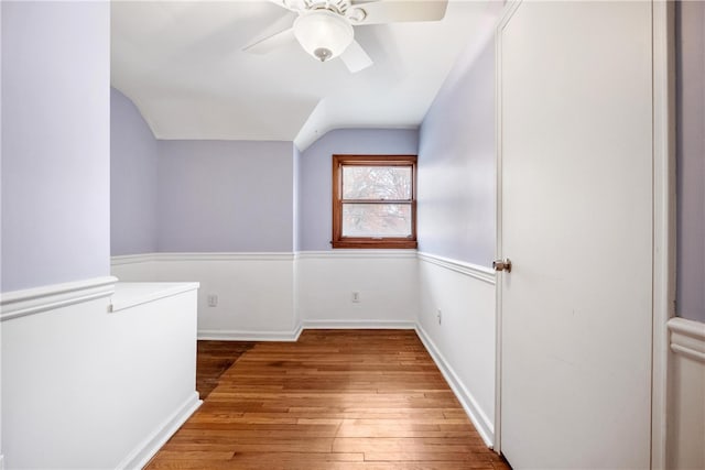 additional living space with lofted ceiling, hardwood / wood-style floors, and ceiling fan