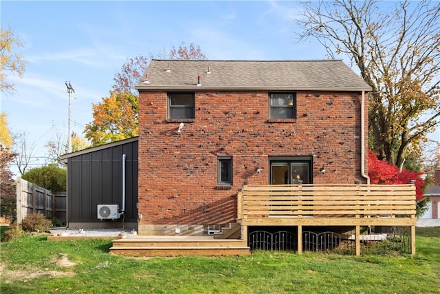 rear view of house featuring ac unit and a yard