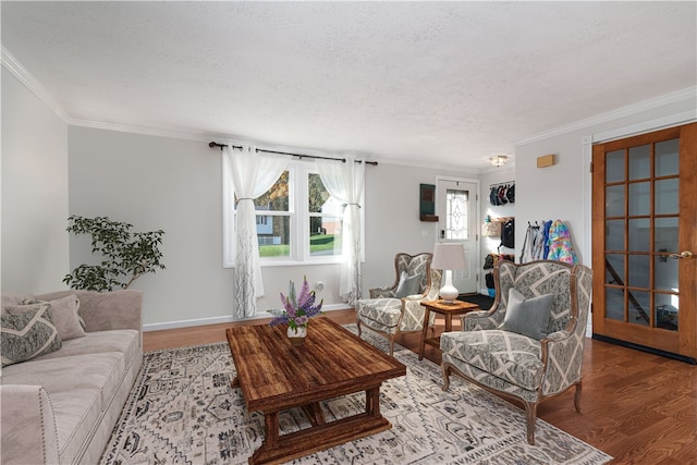 living room with ornamental molding, hardwood / wood-style floors, and a textured ceiling