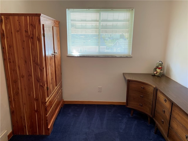 unfurnished bedroom featuring dark carpet