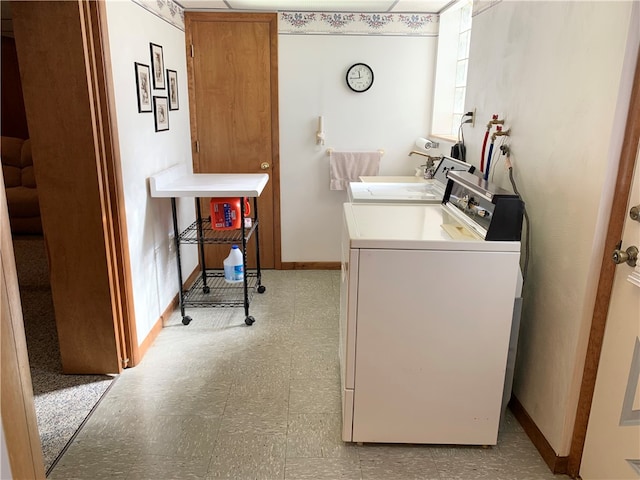 washroom with cabinets and washer and clothes dryer