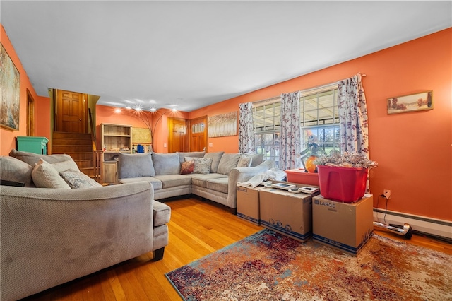 living room featuring baseboard heating and light hardwood / wood-style floors