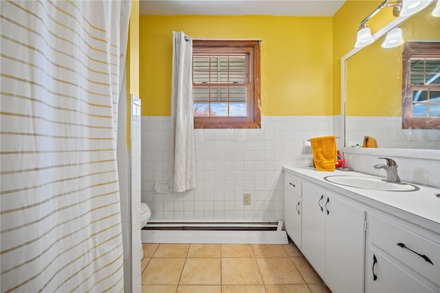 bathroom featuring vanity, toilet, a healthy amount of sunlight, and tile patterned floors