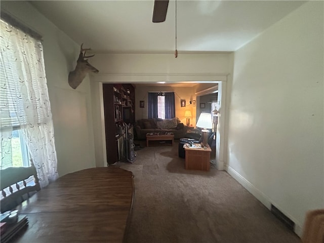 living room with carpet flooring and ceiling fan