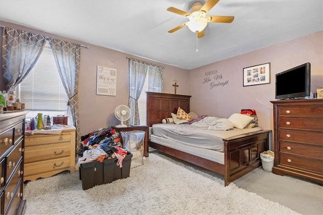 bedroom with ceiling fan and light colored carpet