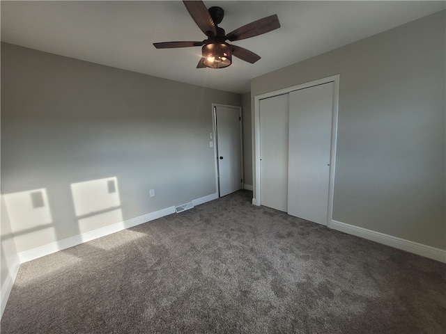 unfurnished bedroom with a closet, carpet flooring, and ceiling fan