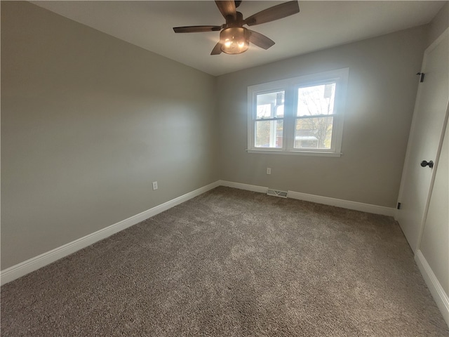 carpeted spare room with ceiling fan