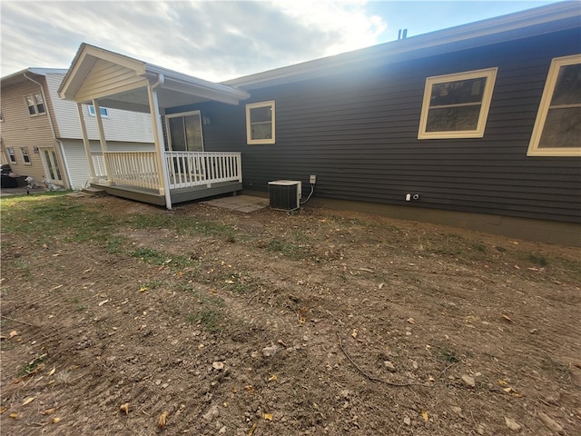 view of side of home with central AC and a deck