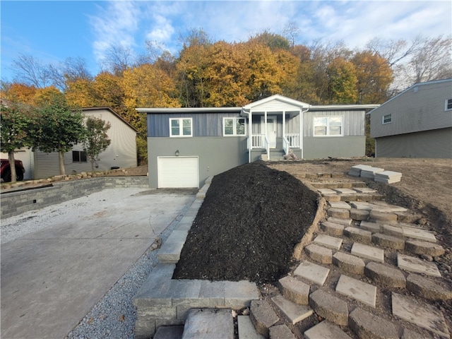 view of front of home with a garage and a sunroom