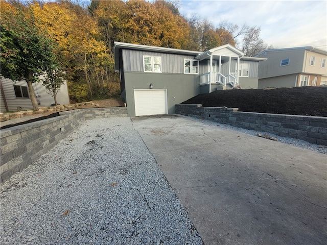 view of front of property with a garage and a sunroom