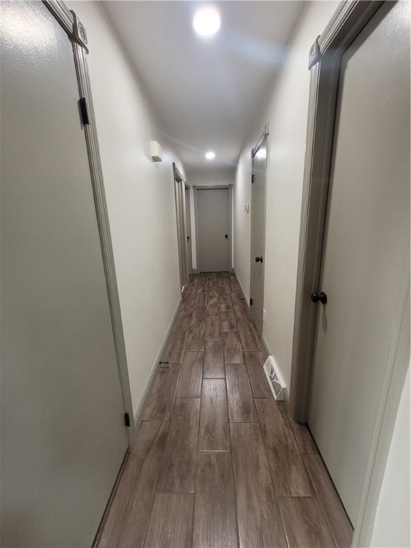 corridor featuring hardwood / wood-style floors