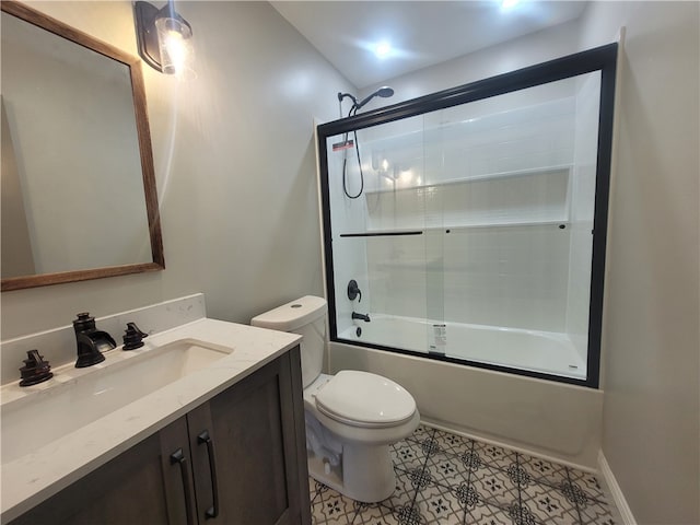 full bathroom with vanity, shower / bath combination with glass door, toilet, and tile patterned floors