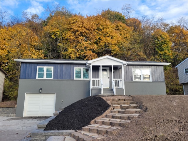 view of front of home featuring a porch and a garage