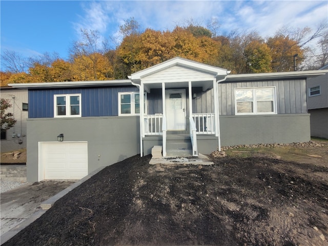 view of front of property featuring covered porch and a garage