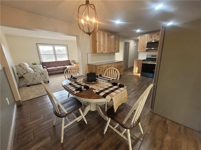 dining area featuring dark wood-type flooring and a chandelier