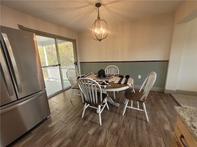 dining room with a notable chandelier and dark hardwood / wood-style floors