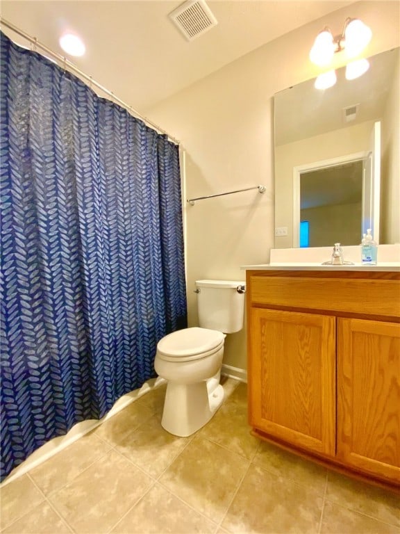 bathroom featuring vanity, curtained shower, toilet, and tile patterned floors