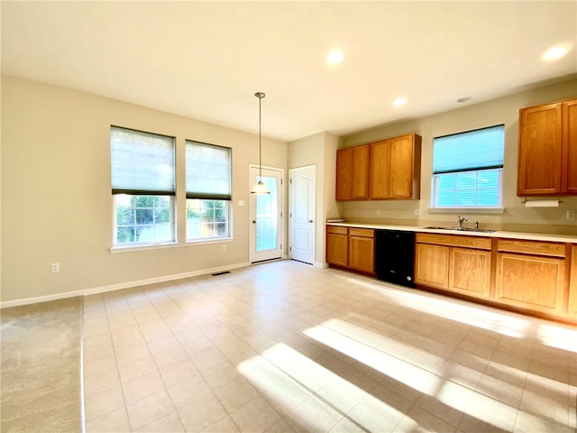 kitchen featuring light tile patterned flooring, black dishwasher, sink, and pendant lighting