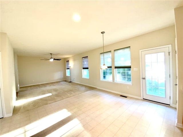 unfurnished living room featuring ceiling fan