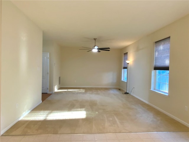 carpeted spare room with ceiling fan