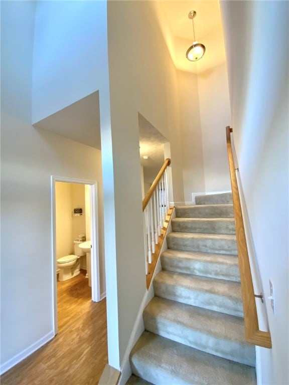 stairs featuring hardwood / wood-style flooring