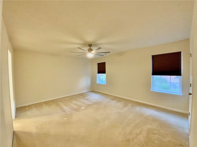 empty room featuring carpet flooring and ceiling fan