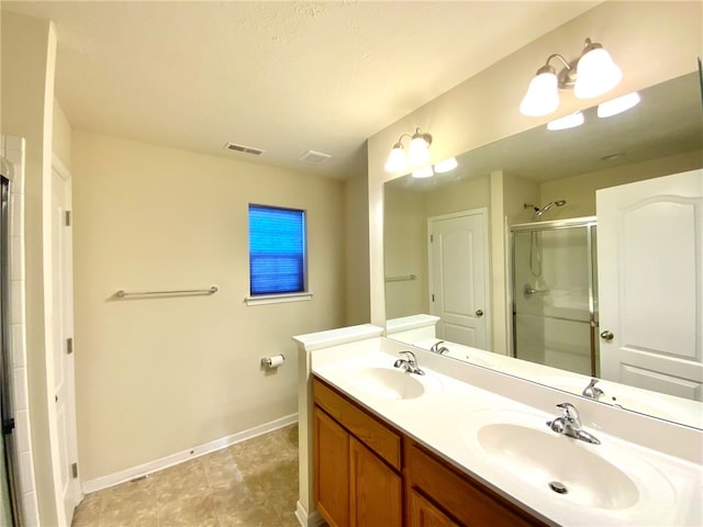 bathroom with vanity, a chandelier, a textured ceiling, and an enclosed shower