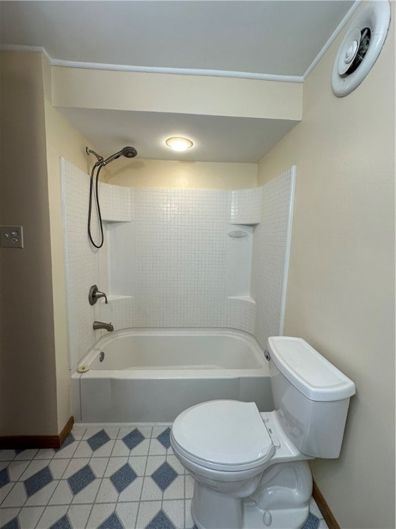 bathroom with tub / shower combination, toilet, and tile patterned flooring