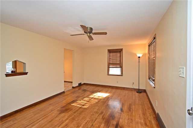 spare room with wood-type flooring and ceiling fan