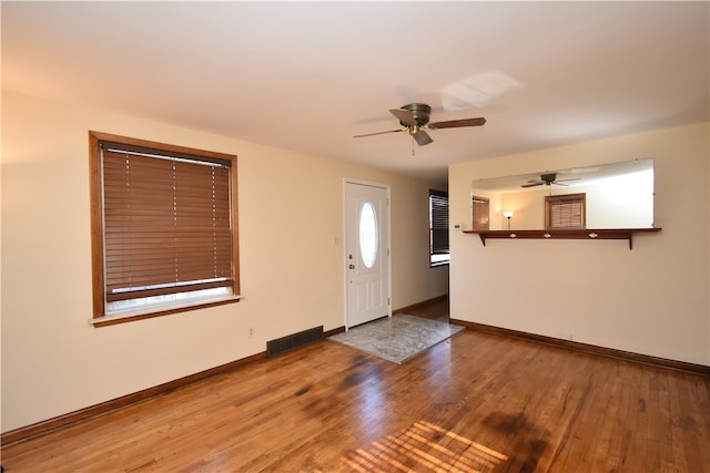 foyer entrance with ceiling fan and hardwood / wood-style floors