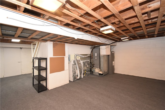 basement featuring electric water heater and heating unit