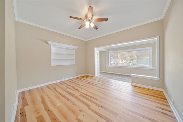 spare room with light hardwood / wood-style floors and crown molding