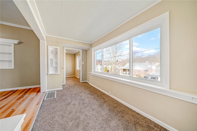 unfurnished bedroom featuring crown molding and light carpet