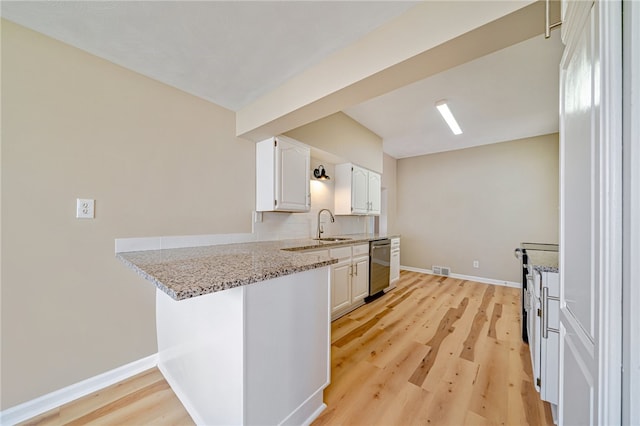 kitchen with light hardwood / wood-style flooring, white cabinets, light stone countertops, and stainless steel dishwasher