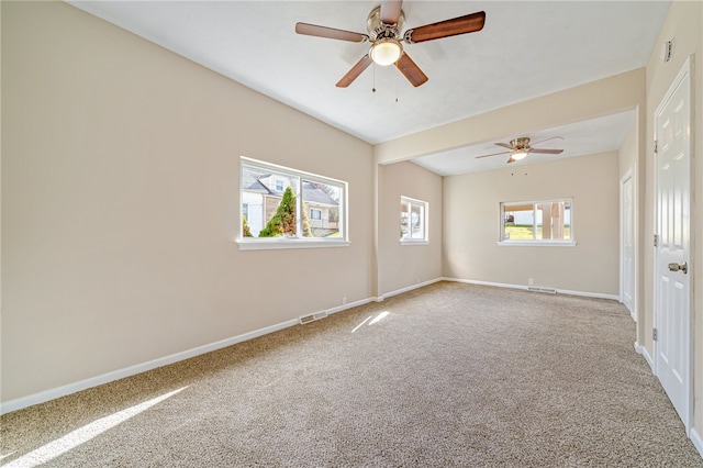 carpeted spare room with ceiling fan