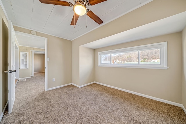 spare room featuring crown molding, light carpet, and ceiling fan