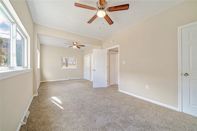 empty room featuring light carpet and ceiling fan