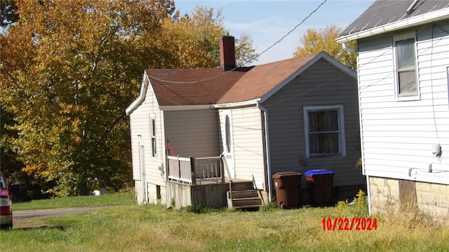 back of property featuring a yard