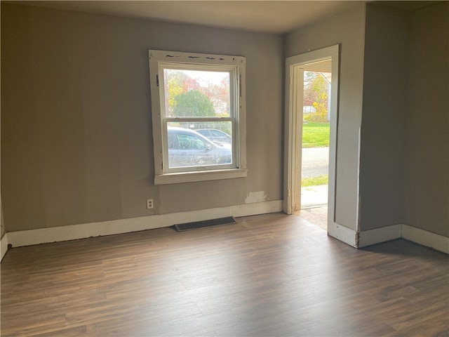 unfurnished room with dark hardwood / wood-style floors