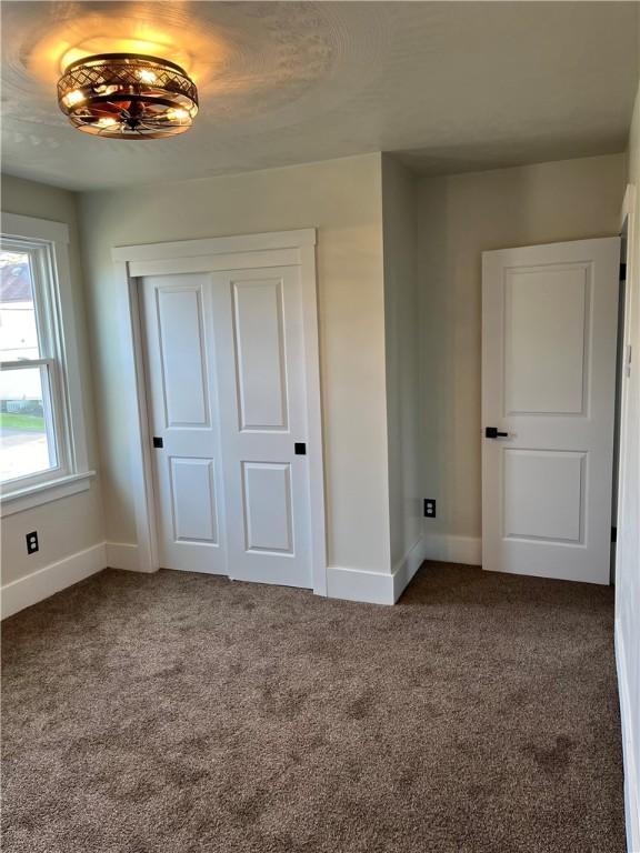 unfurnished bedroom featuring a closet and carpet floors