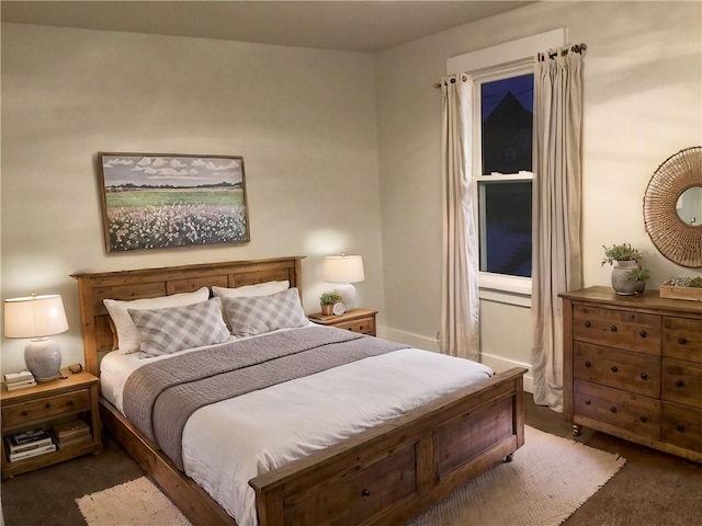 bedroom with dark colored carpet