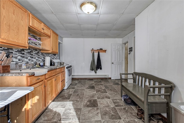 kitchen with tasteful backsplash, a baseboard radiator, a drop ceiling, sink, and white range with gas stovetop