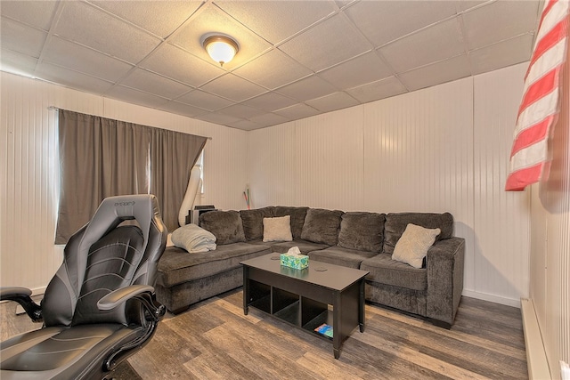 living room featuring a paneled ceiling, hardwood / wood-style flooring, and baseboard heating