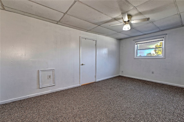 carpeted spare room featuring ceiling fan and a drop ceiling