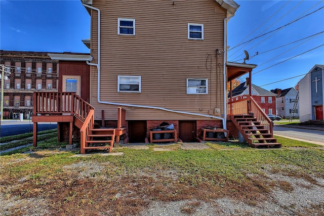 rear view of house featuring a yard