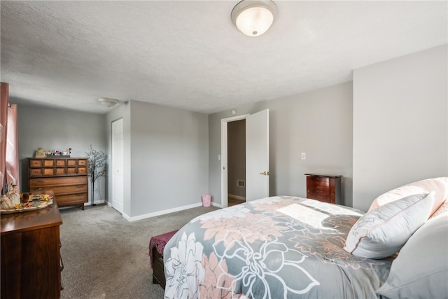 carpeted bedroom featuring a textured ceiling